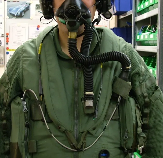 Pilot in a flight suit with breathing mask, connected to the METAMAX® 3B for aeromedical exercise testing